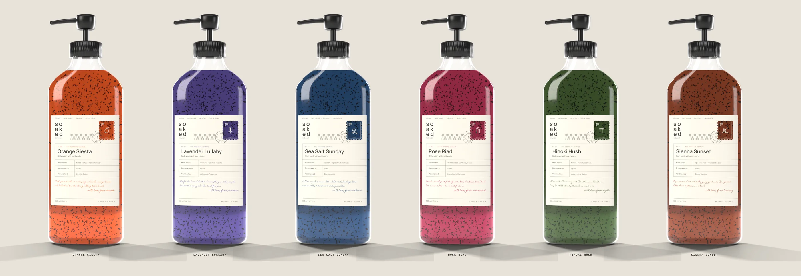 Six Soaked body wash bottles, one colour per scent, with postcard labels